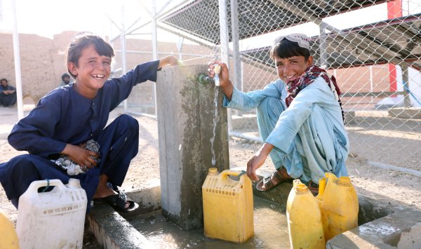 Rashid y Nadi sonriendo cerca de una fuente - Afganistán