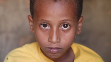 A portrait of Zaid, 9, in his home near Taiz, Yemen